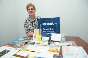 Salmon Arm Neighbourhood Welcome representative Michelle Easterbrook displays the contents of a gift bag that she gives to newcomers. (Lachlan Labere-Salmon Arm Observer)