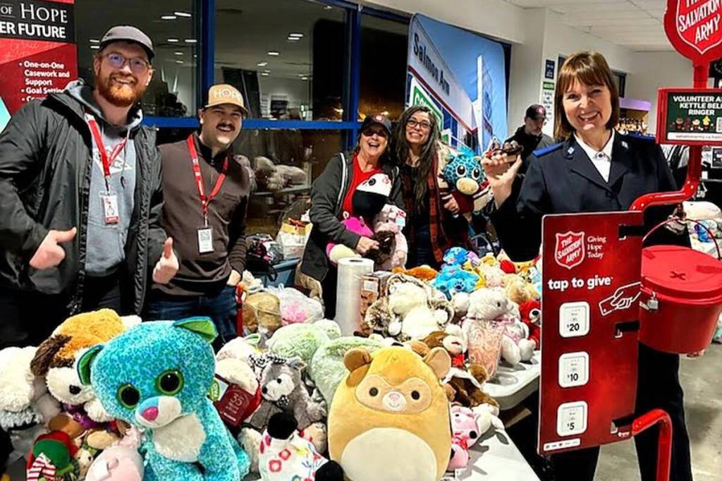 The Salmon Arm Salvation Army crew stand next to a swath of stuffies donated during the 2025 Christmas Kettle Campaign and local toy drives. (Photo contributed)