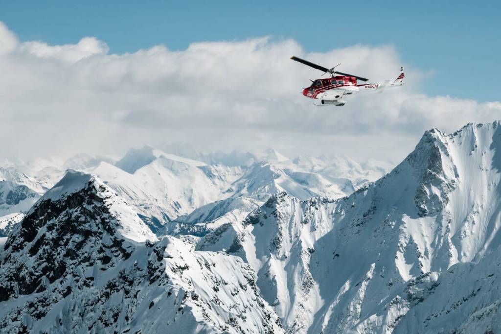 A Selkirk Tangiers Heli Skiing helicopter takes guests for a ride in the Selkirk Mountains near Revelstoke. (Photo courtesy Selkirk Tangiers Heli Skiing/Facebook)